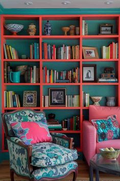 a living room filled with lots of colorful furniture and bookshelves full of books