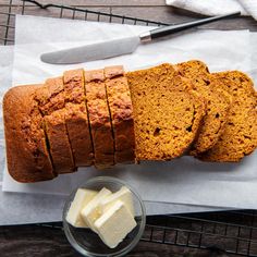 sliced loaf of pumpkin bread with butter on the side