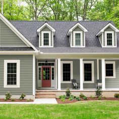 a gray house with white trim and windows