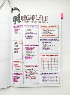 an open planner with the words get organized written in pink and black on it, next to a pair of scissors