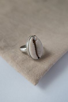 Traditionally Cowrie Shells were used in some parts of Africa as a form of currency and prosperity, bringing also good luck. Available in Golden Brass and Silver Plated.Matching earrings and pendant also available.Tell us your size at checkout, or choose from (EU Size) :Small - 52-54Medium - 56-58Large - 60-62S H I P P I N GWe aim to ship within 1 business day.DOMESTIC ORDERS your items will be sent Tracked and Signed for as standard.INTERNATIONAL ORDERS your order will be sent via standard post Boho Jewellery, Cowrie Shells, Shell Ring, Personalized Notes, Cowrie Shell, Brass Jewelry, Matching Earrings, Free Size, Statement Rings