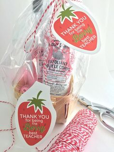 the teacher appreciation gift basket is filled with pink and red candy canes, thank you teacher tags, and twine