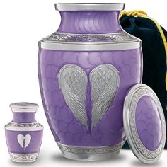 a purple creman with a silver cross on it and two other items next to it