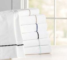 a stack of white sheets sitting on top of a table