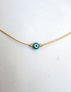 Evil eye choker necklace, String choker, Minimalist The evil eye is used to protect the person that wears it from the malevolent look of others who envy or dislike that person. The necklace is made with 1mm silver/gold waxed string,and has a 8mm emerald glass evil eye bead. At the end it is adorned with seed beads. Total length: 80cm / 31 inches It is adjustable to fit a lot of sizes. Custom orders for different colour combinations are welcome. Other necklaces in my shop: https://www.etsy.com/sh Green Evil Eye, Necklace String, Evil Eye Necklace Gold, Dainty Choker, Blue Evil Eye, Minimal Jewelry, Evil Eye Necklace, Colour Combinations, Short Necklace