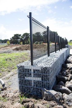 a fence made out of concrete blocks and wire