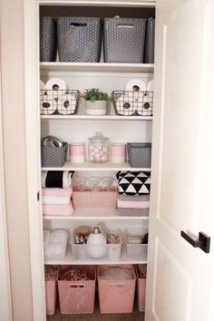 an organized closet for functionality with baskets and bins on the bottom shelf in front of it