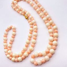 This exquisite coral necklace features an elegant combination of bone white and pale pink beads, meticulously arranged in alternating sizes. Perfect for any occasion, this necklace blends classic charm with a modern aesthetic. The coral beads are strung on a 36" silk thread and finished with 18k bead tops and clasp. Luxury Coral Beaded Necklace With Round Beads, Luxury Coral Beaded Necklaces With Round Beads, Elegant Hand-strung Coral Necklaces, Elegant Coral Hand-strung Necklaces, Elegant Hand-strung Coral Necklace, Elegant Coral Round Bead Necklaces, Elegant Coral Beaded Necklaces, Elegant Coral Beaded Necklaces With Gemstone, Elegant Single Strand Coral Beads