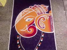 an elephant painted on the ground with beads