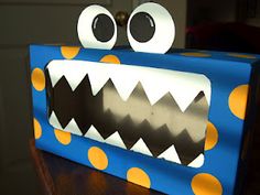 a blue box with yellow polka dots and a monster's mouth painted on it