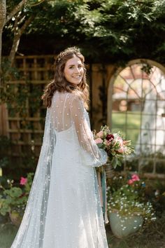 a woman in a white wedding dress holding a bouquet