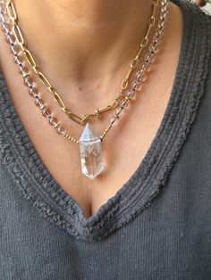 This stunning Clear Quartz Crystal Necklace is the perfect blend of elegance and spiritual energy. Featuring a striking, raw clear quartz point pendant, this necklace is hand-strung with clear quartz beads and gold-tone accents, adding a radiant touch to any outfit. The necklace is both a statement piece and a tool for spiritual healing, designed to amplify positive energies and promote mental clarity. Product Details: *Crystal: Natural Clear Quartz Point *Pendant Size: Approx. 5cm *Chain: Clear Quartz Beads with Gold-tone Spacer Beads *Chain Length: 21cm *Handmade with Love Properties of Clear Quartz: Clear Quartz is known as the "Master Healer," amplifying energy, thoughts, and the effects of other crystals. It is a highly prized stone for those looking to enhance their focus, clarity, a Wrapped Crystal Necklace, Raw Clear Quartz, Natural Gemstone Necklace, Clear Quartz Point, Quartz Crystal Necklace, Spiritual Energy, Quartz Beads, Mental Clarity, Clear Quartz Crystal