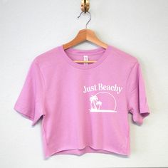 JUST BEACHY Women's Beach Crop Top T-shirt The perfect vacation shirt for women! Shirt colors available: Natural, Sunset Orange, Lilac, Mauve, Soft Pink Women's Sizes Available: XS, S, M, L, XL, XXL Cotton & Polyester Blend Looking for women's vacation clothes? Check out our vacation shop section here: https://www.etsy.com/shop/NobullWomanApparel?ref=seller-platform-mcnav&section_id=38097361 Pink Summer Crop Top Shirt, Pink Summer Cropped Shirt, Pink Cotton Top With Palm Tree Print, Relaxed Fit Short Sleeve Crop Top For Beach, Beach Season Crew Neck Crop Top, Pink Summer Crop Top, Summer Crop Top With Short Sleeves, Pink Crop Top For Summer, Summer Crop Top With Relaxed Fit And Short Sleeves