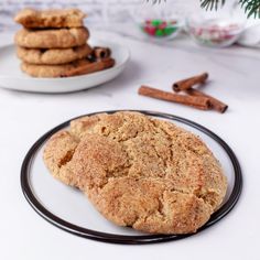 cookies on a plate with cinnamon sticks in the background