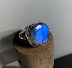 Name :- Labradorite Blue Ring STONE SHAPE : Round STONE Category: Cabochone Ring  SIZE: 9 US  Weight: 36.20 Cts Metal: 925 Sterling Silver plated: Pure Silver Silver Polish: High Polish Announcement :- SPECIAL DISCOUNTs for BIG LOTs for 500 Grams/ 1 KG/5 Kilograms We Accept Custom Order required. If You need Wholesale Big Lots, please let us know and we will offer you best prices according to quantity. * DISCLAIMER: - Actual colors may vary from those shown due to the nature of photographing and monitor color Settings. Shipping:- All the parcels will be shipped within 3 days of purchase... Payment:- We accept payment through Payoneer only. Return:- if you are not satisfied with our product, you may return your order within 14 days from the date of shipment received. The item must be return Healing Natural Stones Opal Ring, Sapphire Moonstone Gemstone Ring, Blue Rings With Large Stone For Healing, Unique Blue Moonstone Ring, Sapphire Colored Moonstone Ring As Gift, Sapphire Color Moonstone Ring As A Gift, Sapphire Moonstone Ring Perfect As A Gift, Adjustable Blue Moonstone Ring Gift, Blue Round Gemstones Stamped 925