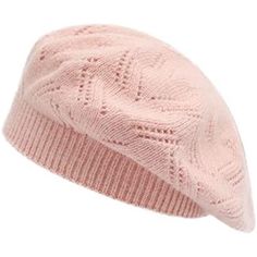 a pink knitted beanie hat with an intricate design on the front and side