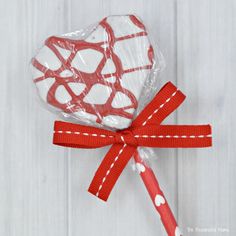 a heart shaped lollipop wrapped in cellophane