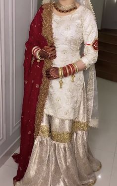 a woman in a white and red wedding outfit