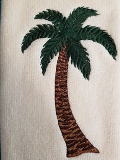 a towel with a palm tree embroidered on it