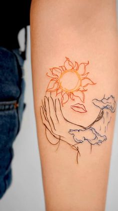 a woman's arm with a sun and clouds tattoo on the left side of her body