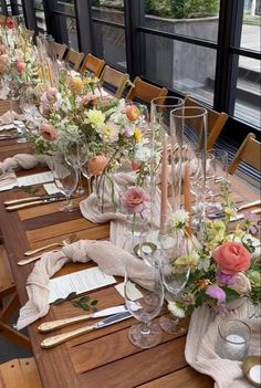 a long table is set with flowers and place settings