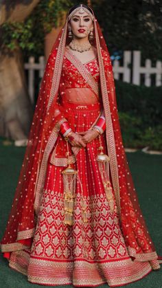 the bride in her red and gold wedding outfit