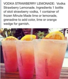 two glasses filled with lemonade sitting on top of a table next to each other