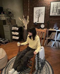 a woman sitting on top of a rocking chair