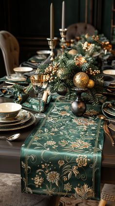 the table is set for christmas dinner with green and gold decorations on top of it