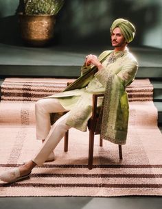 Step into refined elegance with the Pista Barfi sherwani, a soothing sage green ensemble ideal for daytime celebrations. Adorned with intricate zardozi and dabka embroidery, this sherwani features a medley of signature motifs, complemented by contrasting trousers and kurta. A perfect balance of tradition and sophistication, reminiscent of its namesake sweet. It comes with an optional dupatta. Bollywood Style Pista Green Jamawar Sets, Green Naqshi Anarkali Set For Eid, Festive Green Anarkali Set With Naqshi Detail, Festive Green Anarkali Set With Naqshi, Eid Green Anarkali Set With Naqshi Detailing, Traditional Green Dupatta With Naqshi, Green Naqshi Dupatta In Traditional Drape, Green Dupatta With Naqshi In Traditional Drape, Green Traditional Anarkali Set With Naqshi