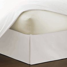 a bed with white sheets on top of it