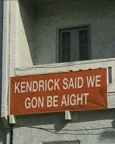 a sign on the side of a building that says, kentucky said we gon be alright