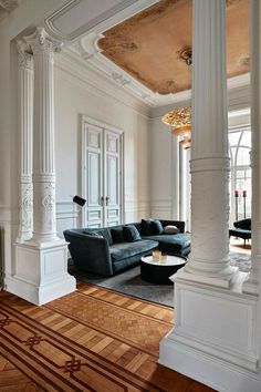 an elegant living room with white walls and wood floors