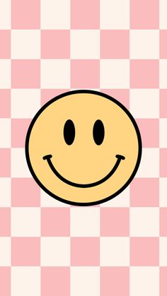 a yellow smiley face on a pink and white checkered background