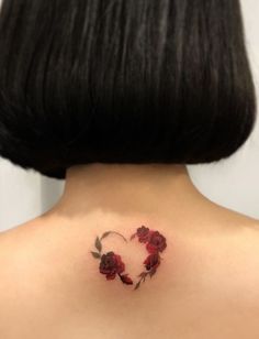 a woman with a heart shaped rose tattoo on her back