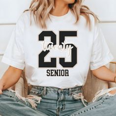 Embrace Your Journey: Class of '25! This vintage-inspired graduation shirt for seniors combines a stylish retro font with a classic graduation cap motif, symbolizing your triumphant academic milestone. Celebrate your high school achievements in timeless fashion, as you step into the next exciting chapter of your life. PRODUCTION TIME: 1-3 days (Usually 2 days) SHIPPING TIME: 2-5 days (Usually 3 days) PRODUCT DESCRIPTION: Bella Canvas Unisex T-shirt Super soft cotton and excellent quality print makes. 100% Soft cotton (fibre content may vary for different colors) Light fabric (4.2 oz/yd² (142 g/m Runs true to size Our Relaxed Fit Tee (Bella + Canvas style 3001) is a unisex style that runs a touch small for men, and about a half a size large for women. It's a relaxed fit and is soft and cozy Senior T-shirt Ideas 2024, Senior Class Shirts Gender Neutral, Senior 2025 Shirts, Senior Shirt Ideas 2025 Trendy, The Proud Senior Shirt, Senior Class Shirts, Class Shirt, Senior Shirts, Graduation Shirts