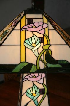 a stained glass lamp with flowers on it