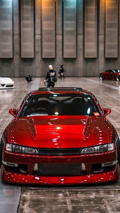 a red sports car parked in a garage