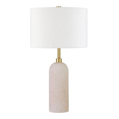 a white table lamp with a gold base and a white linen shade on the top