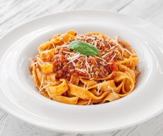 a white plate topped with pasta and sauce