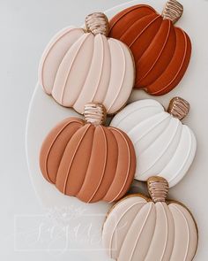 four decorated cookies sitting on top of a white plate