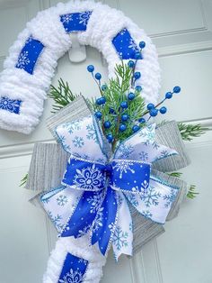 a blue and white snowflake wreath on a door