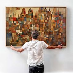 a man standing in front of a large painting