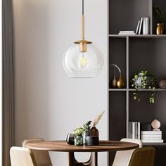 a dining room table with chairs and a hanging light