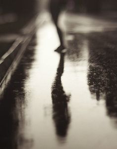 a person walking down the street in the rain