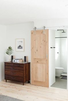 a bathroom with a wooden cabinet and white walls