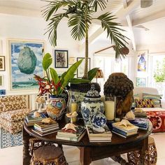 a living room filled with furniture and a potted plant on top of a table