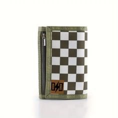 Experience the thrill of the race with the Dirty Rebel Checker Boys Wallet in bold green. Made for young rebels, this wallet features a checkered design and offers a secure and stylish way to carry money. Elevate your style game and keep your cash safe with this ultimate racing wallet. Measures approximately 5" x 3" Cash Safe, Checkered Design, Dog Hoodie, The Race, Kids Swimming, Beanie Hats, Pet Accessories, Hoodies Womens, Shoe Boots