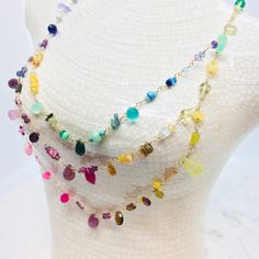 Turn heads with this rainbow multi gemstone 14K gold filled necklace with 3 strands of wire wrapped stone beads made of Rubies,Citrine, fire Opals, Emeralds, Aquamarine, Onyx, Sapphires, sea glass Turquoise, Amethyst, Ametrine, Kyanite , Alexandrite, Garnet, Chalcedony, Chrysoprase,Agate,Lapis Lazuli,Topaz,Opals, Larimar, Rose Quartz, Pink Quartz, Tourmaline, Iolite, Apatite and more. You will have a wearable work of art to match any outfit! Dress it up at the office or dress it down with your f Bohemian Multicolor Briolette Jewelry, Rainbow Multi-strand Necklace As Gift, Rainbow Multi-strand Necklace Gift, Rainbow Multi-strand Necklace For Gift, Rainbow Necklaces With Natural Stones For Jewelry Making, Handmade Rainbow Multi-strand Necklace, Multicolor Gemstone Lariat Jewelry, Rainbow Multi-stone Jewelry For Jewelry Making, Rainbow Multi-strand Jewelry For Gifts