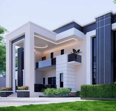 a white and black house with plants in the front yard